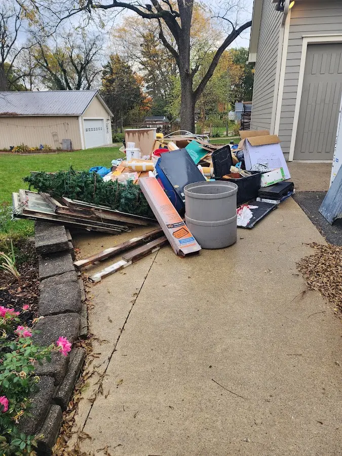 Dumpster being loaded with debris for 30 Yard Dumpster Rental in Tyrone